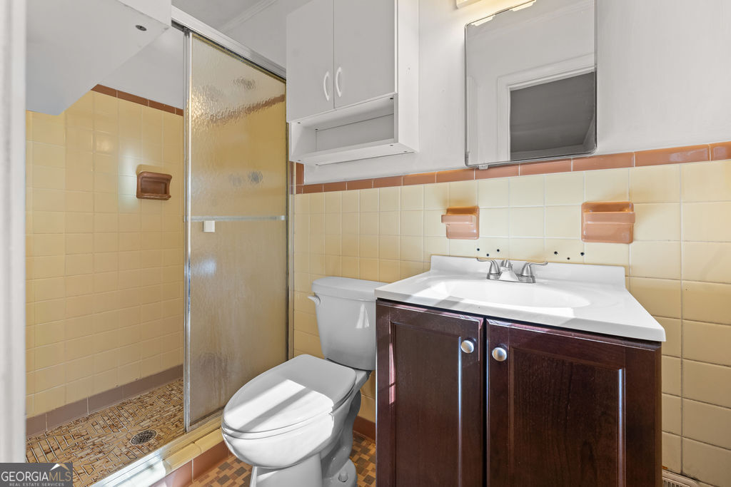 130 Club Drive Stockbridge, GA 30281 - Photo 17 of 28 a bathroom with a sink a toilet and shower
