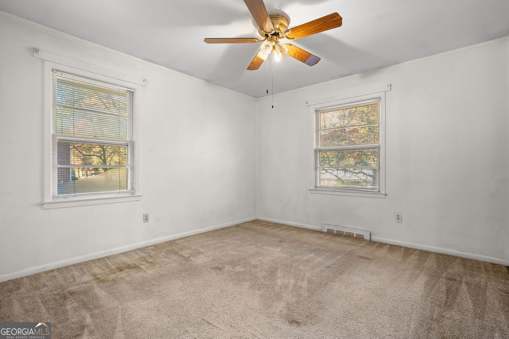 130 Club Drive Stockbridge, GA 30281 - Photo 19 of 28 an empty room with windows and fan