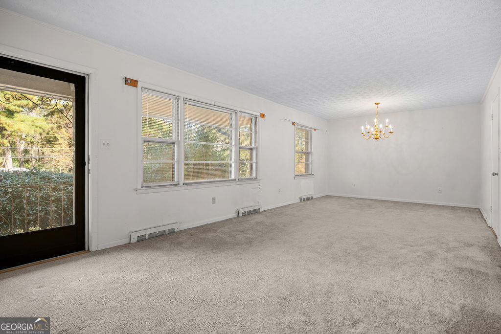 130 Club Drive Stockbridge, GA 30281 - Photo 4 of 28 an empty room with windows