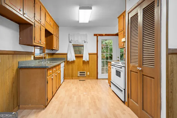 a kitchen with stainless steel appliances granite countertop a sink and cabinets