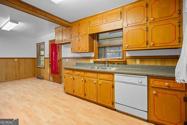 a kitchen with a stove a sink and a refrigerator