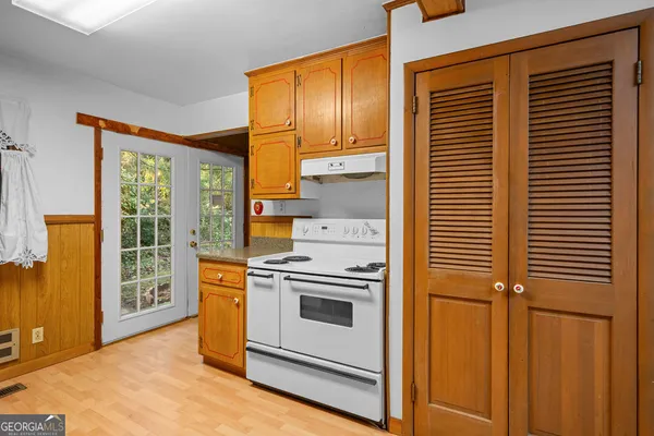 a view of a room with wooden floor