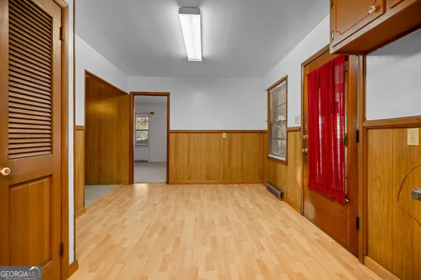 a view of an empty room with a fireplace and a window