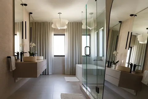 a bathroom with a tub a sink a mirror and a shower