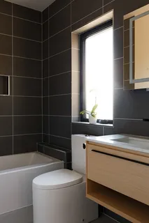 a bathroom with a sink a toilet a mirror and a bathtub