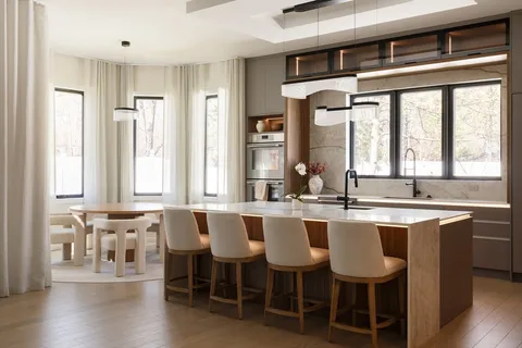 a large kitchen with lots of counter space and dining table