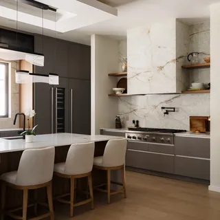 a kitchen with stainless steel appliances granite countertop a table chairs stove and sink