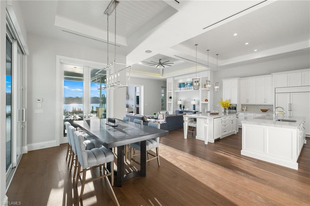 2649 Tarpon Road Naples, FL 34102 - Photo 11 of 50 a view of a dining room with furniture and wooden floor