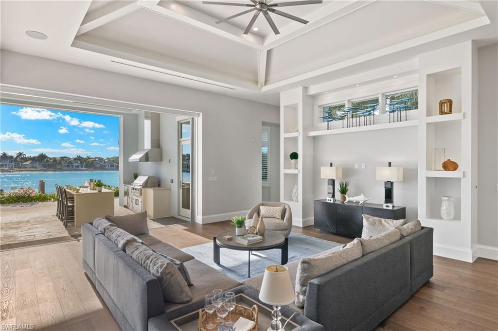 2649 Tarpon Road Naples, FL 34102 - Photo 14 of 50 a living room with furniture and a floor to ceiling window