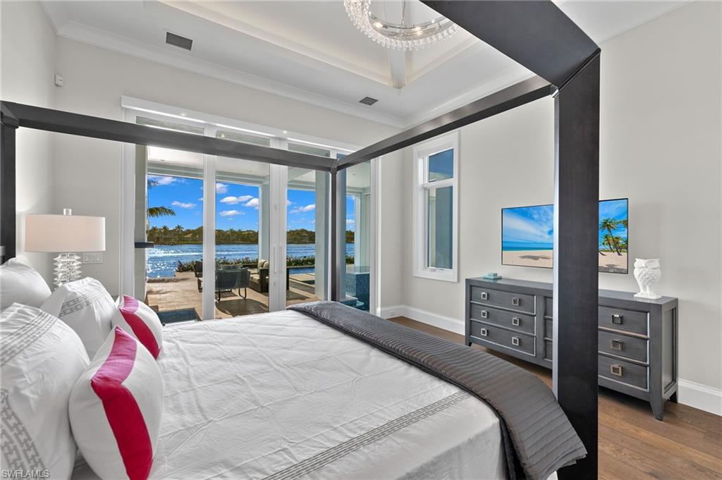 2649 Tarpon Road Naples, FL 34102 - Photo 19 of 50 a bedroom with a bed and a large window