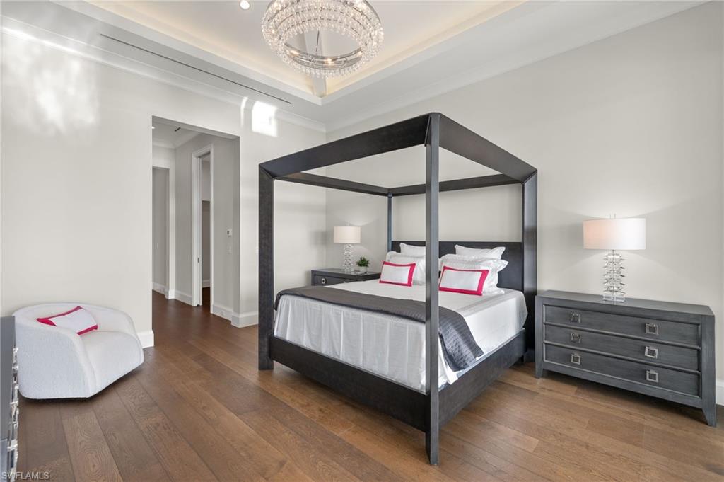 2649 Tarpon Road Naples, FL 34102 - Photo 20 of 50 a bedroom with a bed chandelier and a window