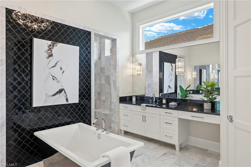 2649 Tarpon Road Naples, FL 34102 - Photo 22 of 50 a bathroom with a sink and a mirror