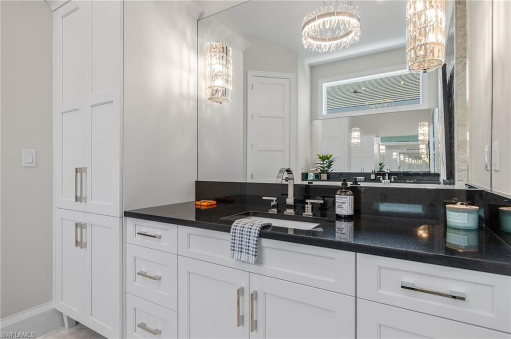 2649 Tarpon Road Naples, FL 34102 - Photo 23 of 50 a bathroom with a sink and a mirror