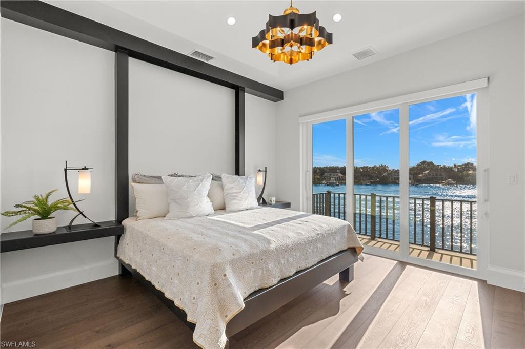 2649 Tarpon Road Naples, FL 34102 - Photo 28 of 50 a bedroom with a bed and a large window
