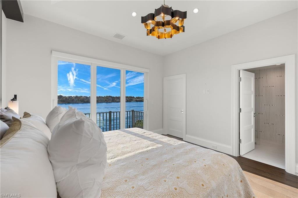 2649 Tarpon Road Naples, FL 34102 - Photo 29 of 50 a bed sitting in a bedroom next to a window