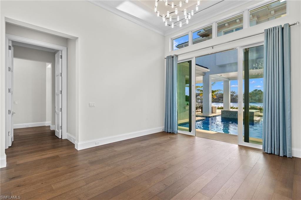 2649 Tarpon Road Naples, FL 34102 - Photo 31 of 50 a view of an empty room with wooden floor