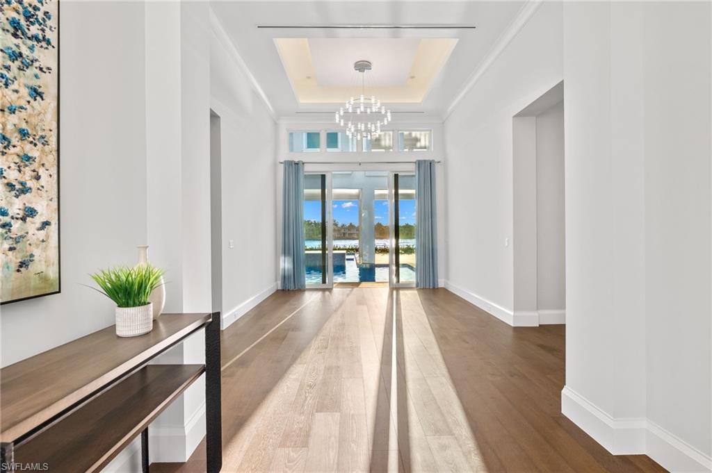2649 Tarpon Road Naples, FL 34102 - Photo 32 of 50 a view of a room with wooden floor potted plant and windows