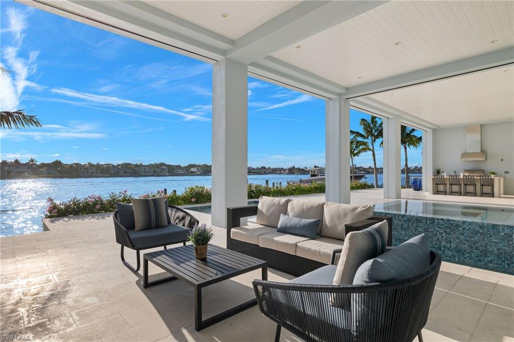 2649 Tarpon Road Naples, FL 34102 - Photo 4 of 50 a outdoor living space with furniture and garden view