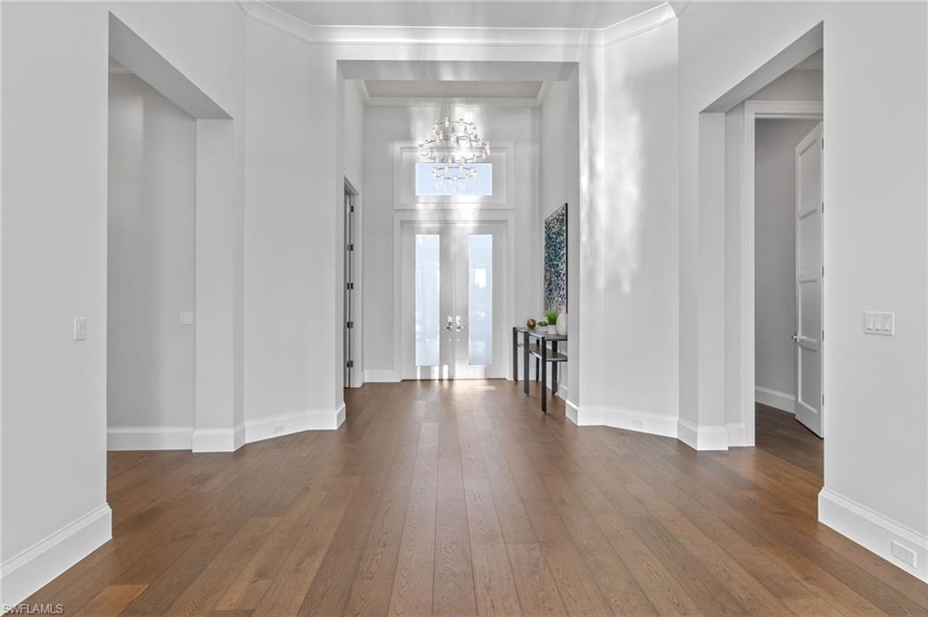 2649 Tarpon Road Naples, FL 34102 - Photo 41 of 50 a view of a hallway with wooden floor