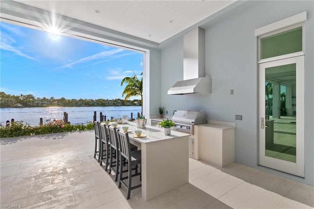 2649 Tarpon Road Naples, FL 34102 - Photo 6 of 50 a view of a patio with wooden floor and lake view