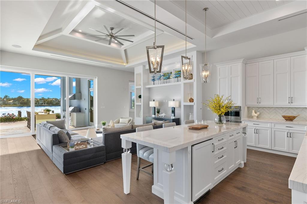 2649 Tarpon Road Naples, FL 34102 - Photo 8 of 50 a large white kitchen with a large window a sink and cabinets