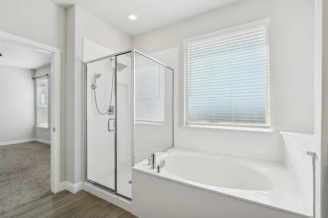 a bathroom with a bathtub and a shower