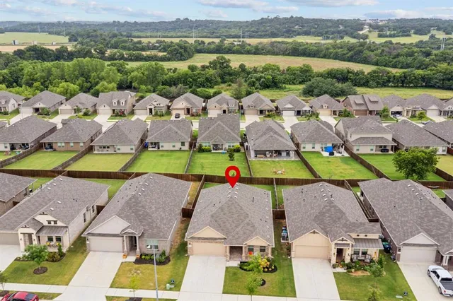 an aerial view of houses with a swimming pool