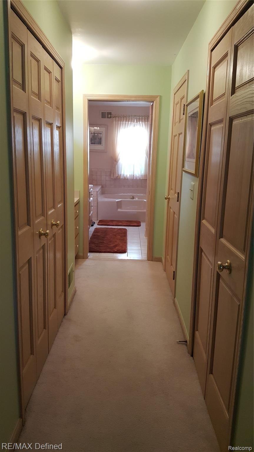 30769 Country Ridge Circle Farmington, MI 48331 - Photo 17 of 31 Hallway to master bathroom, double and walk in closets!