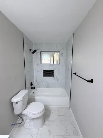 a bathroom with a toilet sink and shower