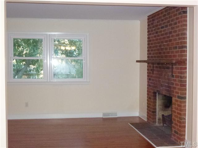 1714 Euclid Road Durham, NC 27713 - Photo 5 of 25 Standing at the Dinning room opening you see the FP from a different angle but you also see the great vinyl replacment windows that are throughout the home and add beauty and energy efficiency to the home. Again all new paint everywhere.