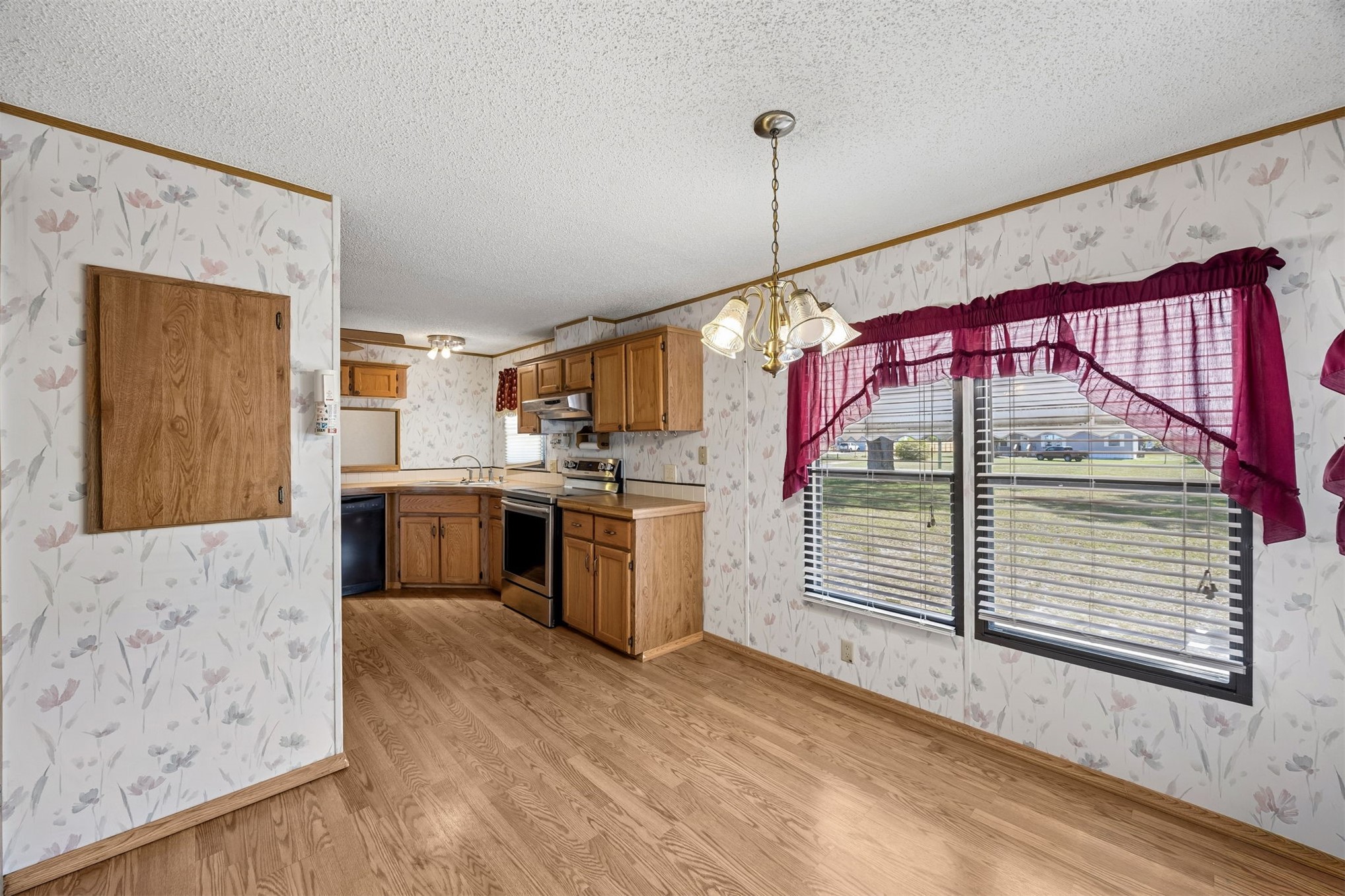 85256 Stephen Road Yulee, FL 32097 - Photo 26 of 48 a kitchen view with stainless steel appliances kitchen island granite countertop a stove a sink and a wooden floors