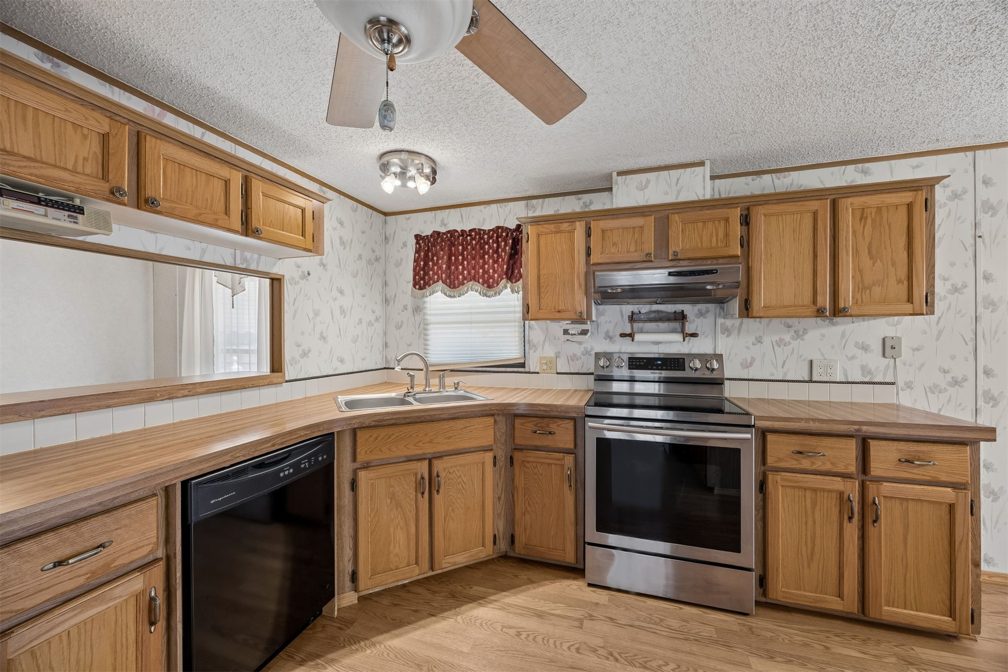 85256 Stephen Road Yulee, FL 32097 - Photo 27 of 48 a kitchen with stainless steel appliances granite countertop a stove sink and cabinets