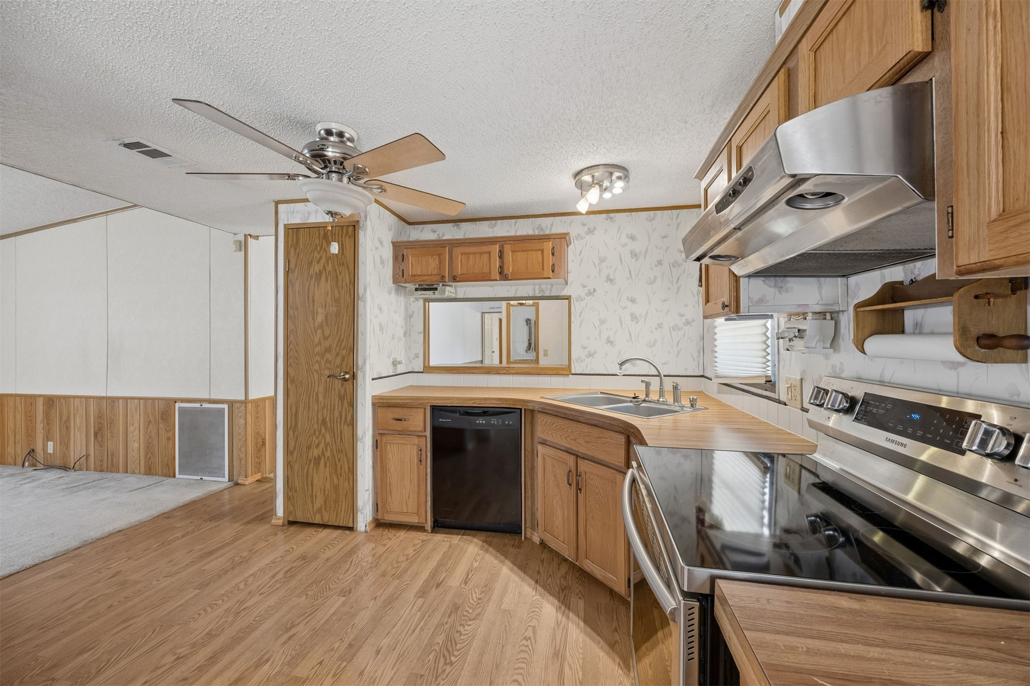 85256 Stephen Road Yulee, FL 32097 - Photo 28 of 48 a kitchen with stainless steel appliances granite countertop a sink stove and refrigerator