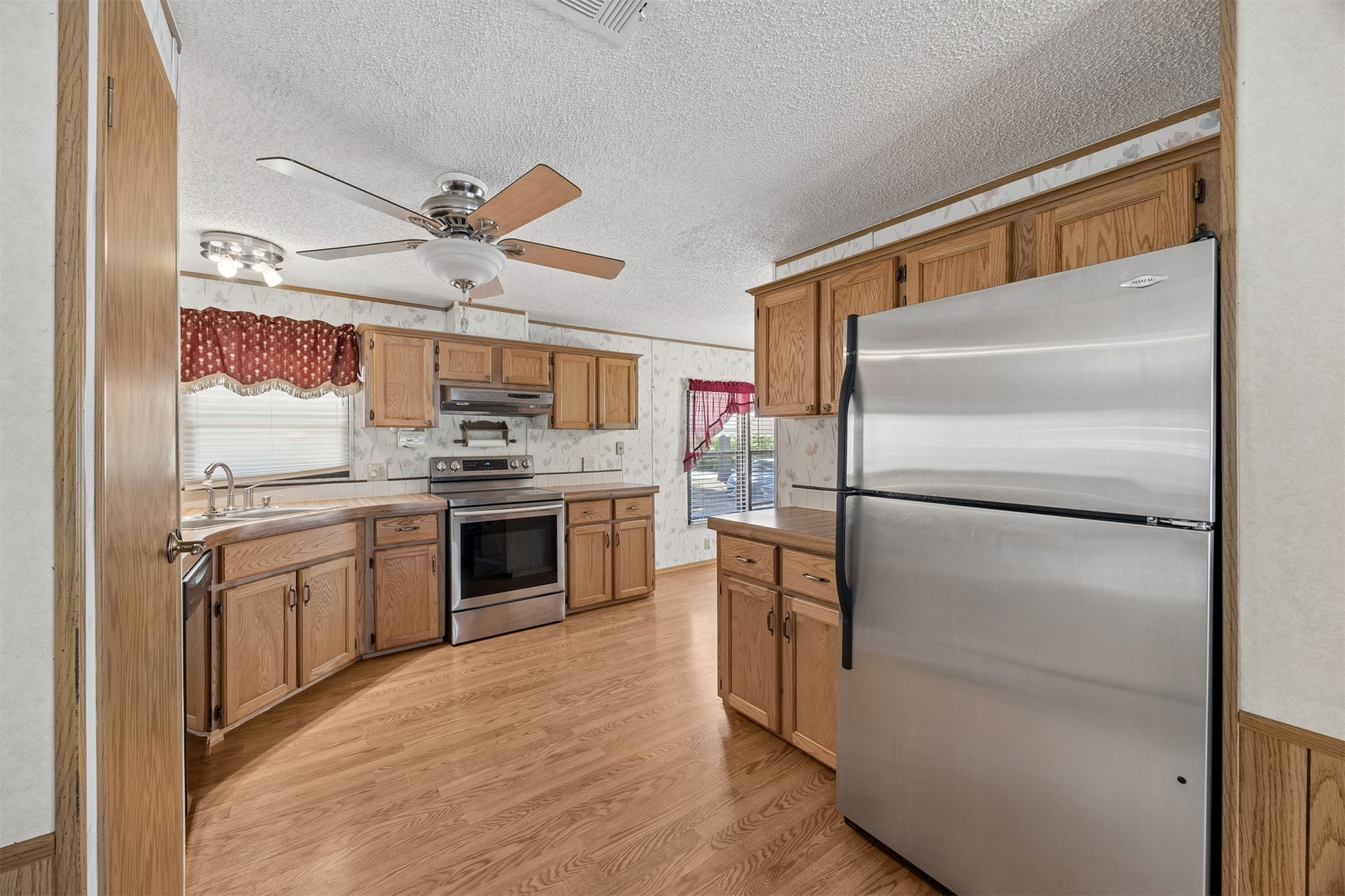 85256 Stephen Road Yulee, FL 32097 - Photo 3 of 48 a kitchen with stainless steel appliances a refrigerator sink and cabinets