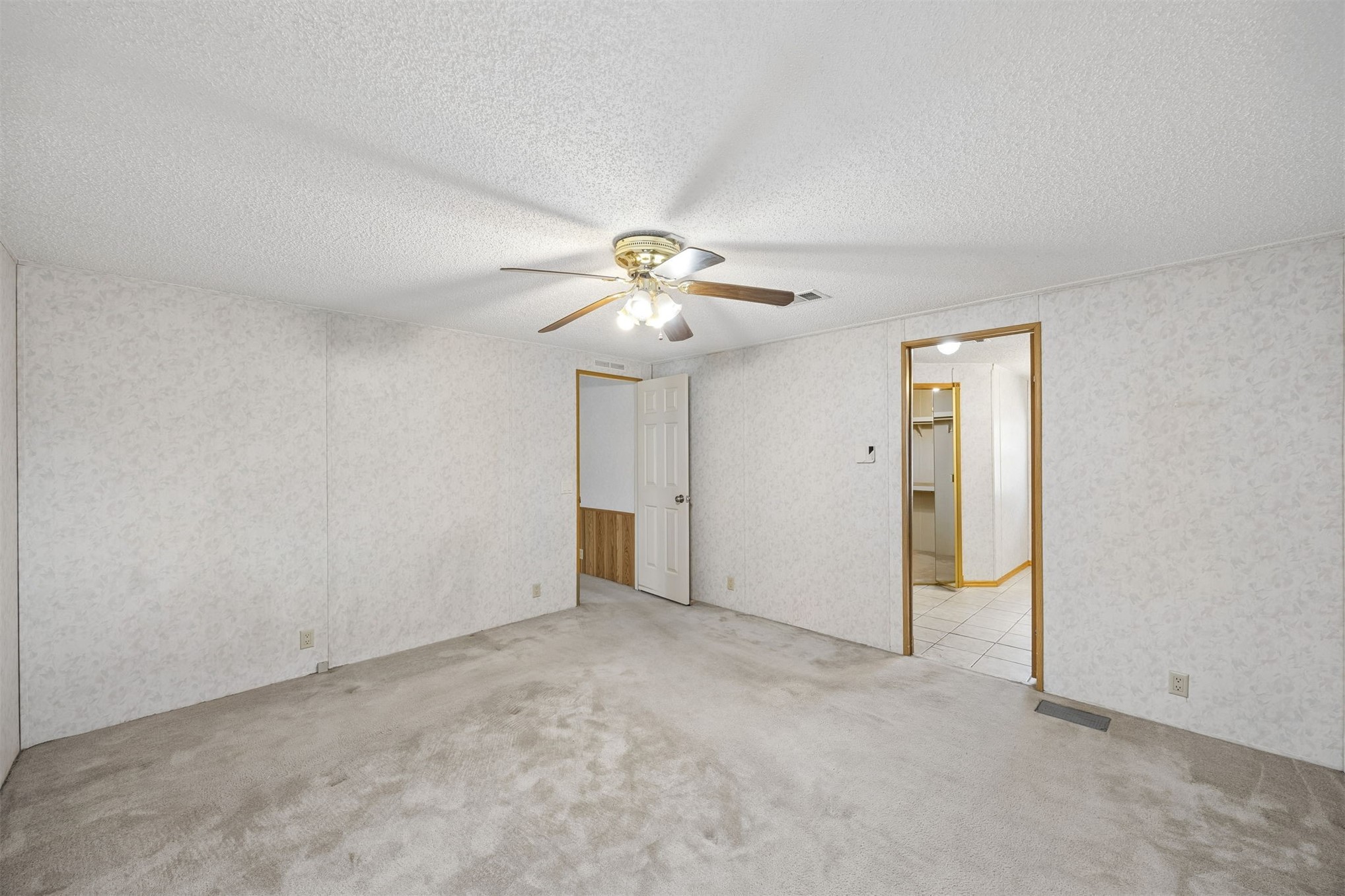 85256 Stephen Road Yulee, FL 32097 - Photo 31 of 48 a view of an empty room with a chandelier fan