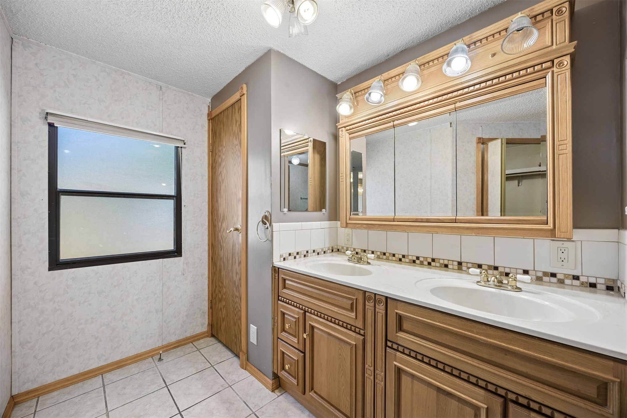 85256 Stephen Road Yulee, FL 32097 - Photo 32 of 48 a bathroom with a sink and a mirror
