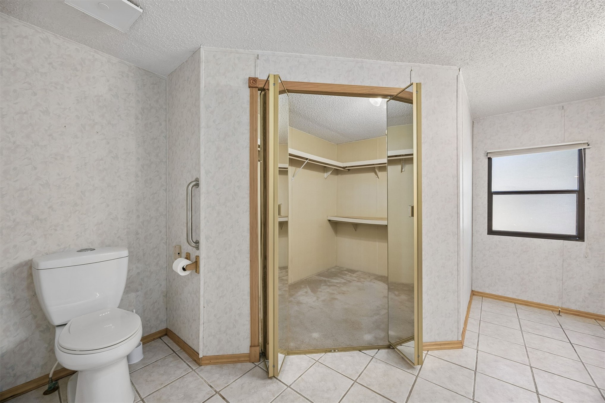 85256 Stephen Road Yulee, FL 32097 - Photo 34 of 48 a bathroom with a granite countertop toilet and a shower