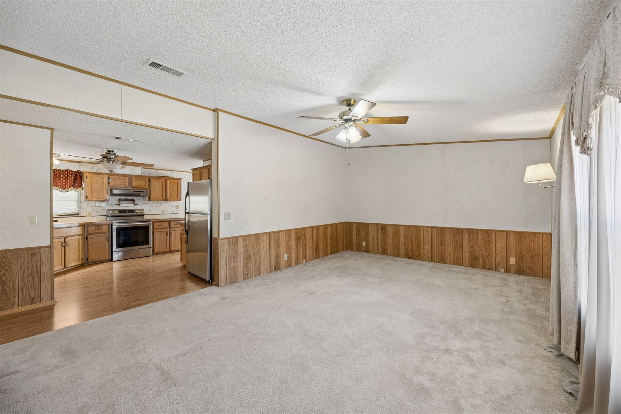 85256 Stephen Road Yulee, FL 32097 - Photo 5 of 48 a view of an empty room with kitchen and window