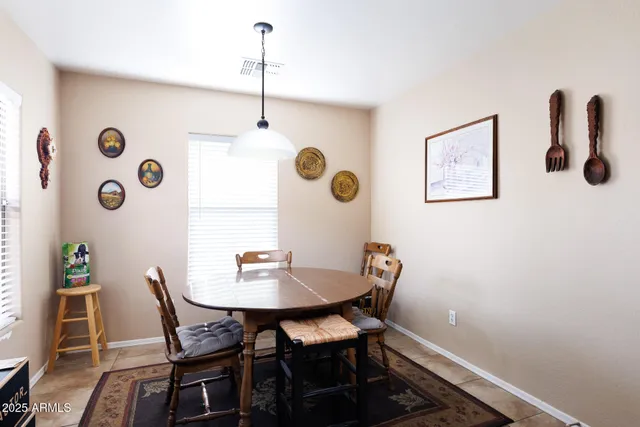 a living room with furniture a rug and a ceiling fan