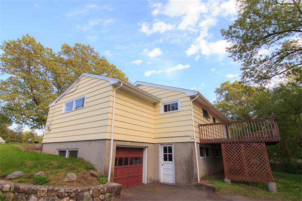1347 Bay Road Sharon, MA 02067 - Photo 7 of 19 a view of a white house with a small yard and large tree