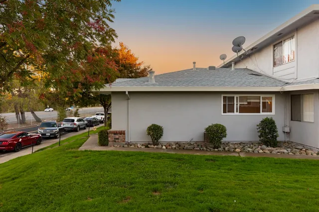 a backyard of a house with table and chairs