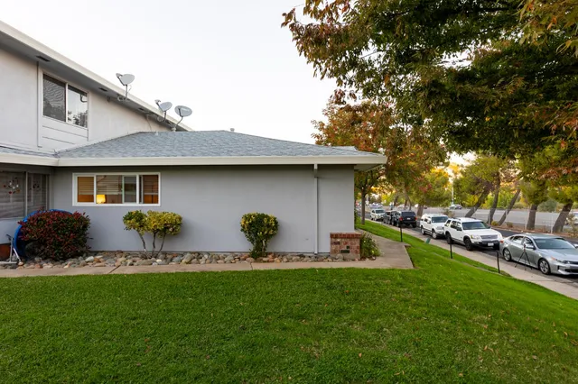 a backyard of a house with table and chairs