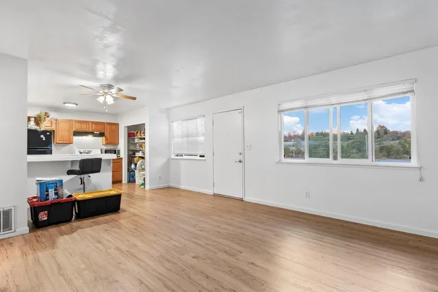 a view of an empty room with a window and storage