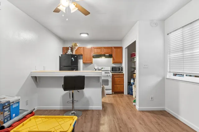 a kitchen with a refrigerator and a stove top oven