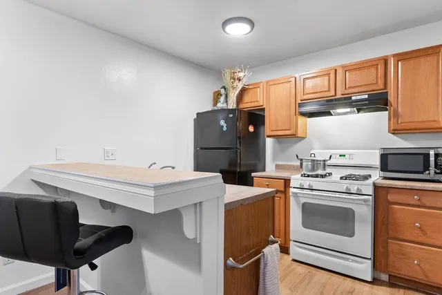 a kitchen with a stove top oven sink and cabinets