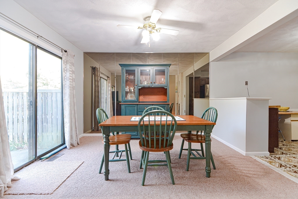 23 Tamarack Lane, Unit 23 Peabody, MA 01960 - Photo 11 of 42 a view of a dining room with furniture window and outside view