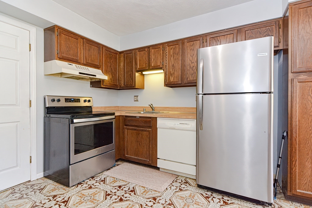 23 Tamarack Lane, Unit 23 Peabody, MA 01960 - Photo 13 of 42 a kitchen with a refrigerator sink and microwave