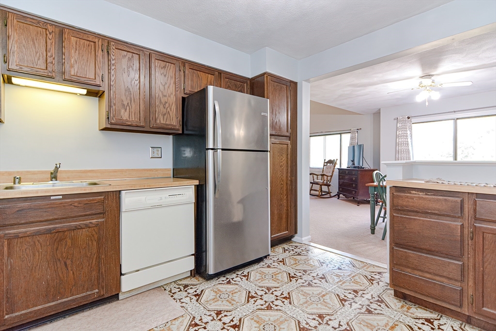 23 Tamarack Lane, Unit 23 Peabody, MA 01960 - Photo 14 of 42 a kitchen with a refrigerator and cabinets