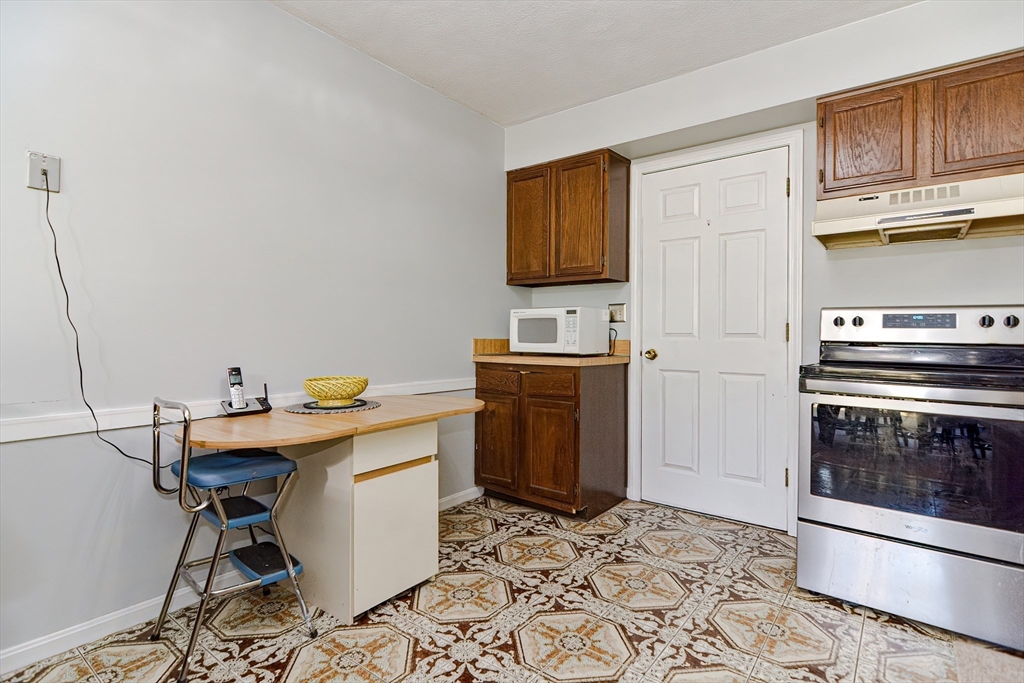 23 Tamarack Lane, Unit 23 Peabody, MA 01960 - Photo 16 of 42 a view of kitchen with sink stainless steel appliances and cabinets