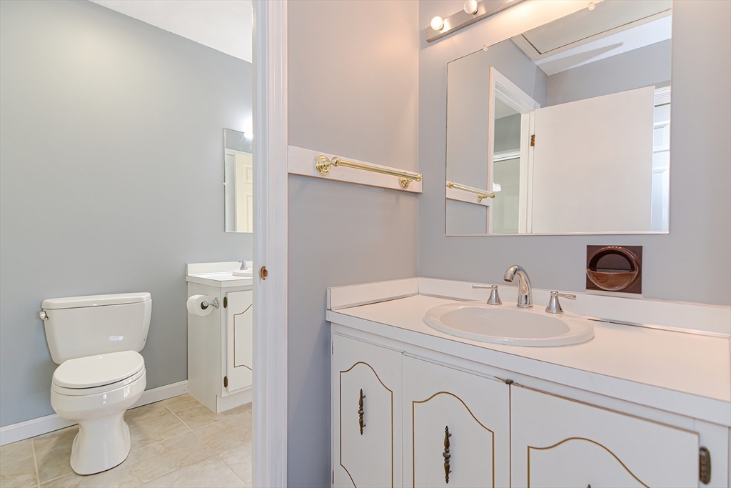 23 Tamarack Lane, Unit 23 Peabody, MA 01960 - Photo 23 of 42 a bathroom with a toilet sink and mirror